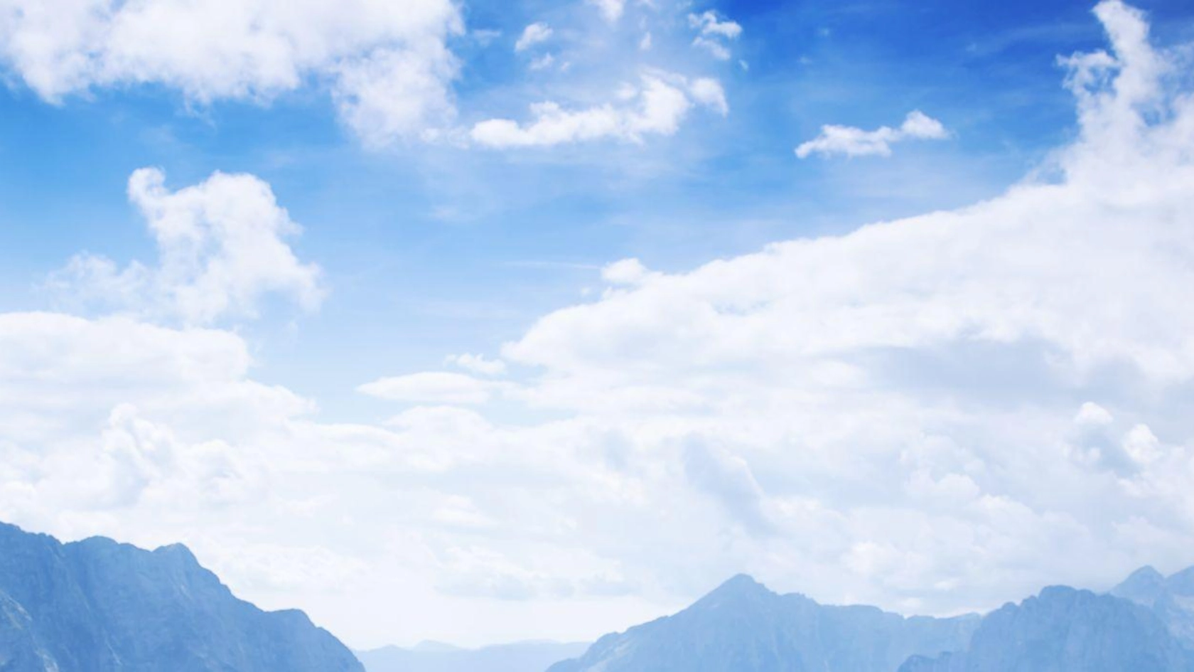 Couple of travelers (hikers) on top of a mountain enjoying valley view. Mangart is a mountain in the Julian Alps, located between Italy and Slovenia. Travel, Holidays, Freedom and Lifestyle Concept